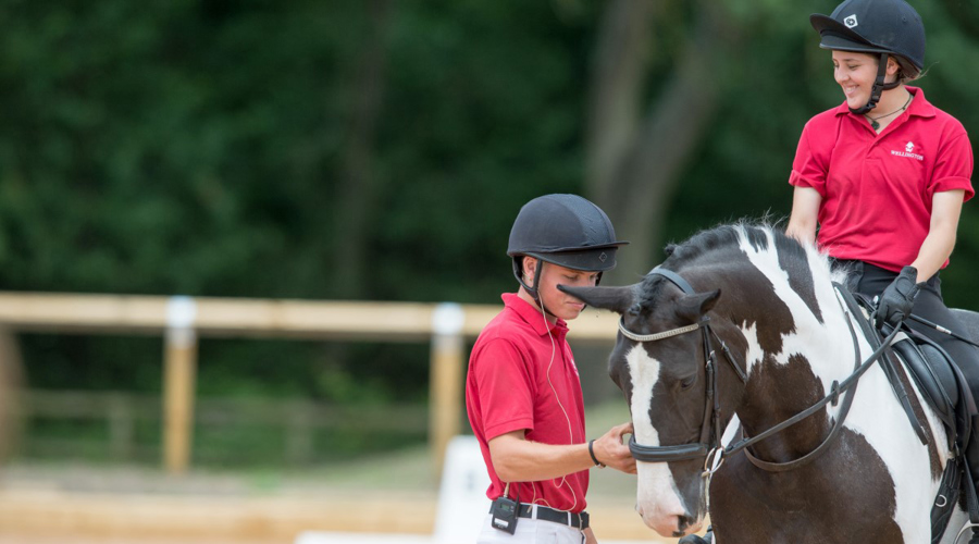 two young riders near a horse