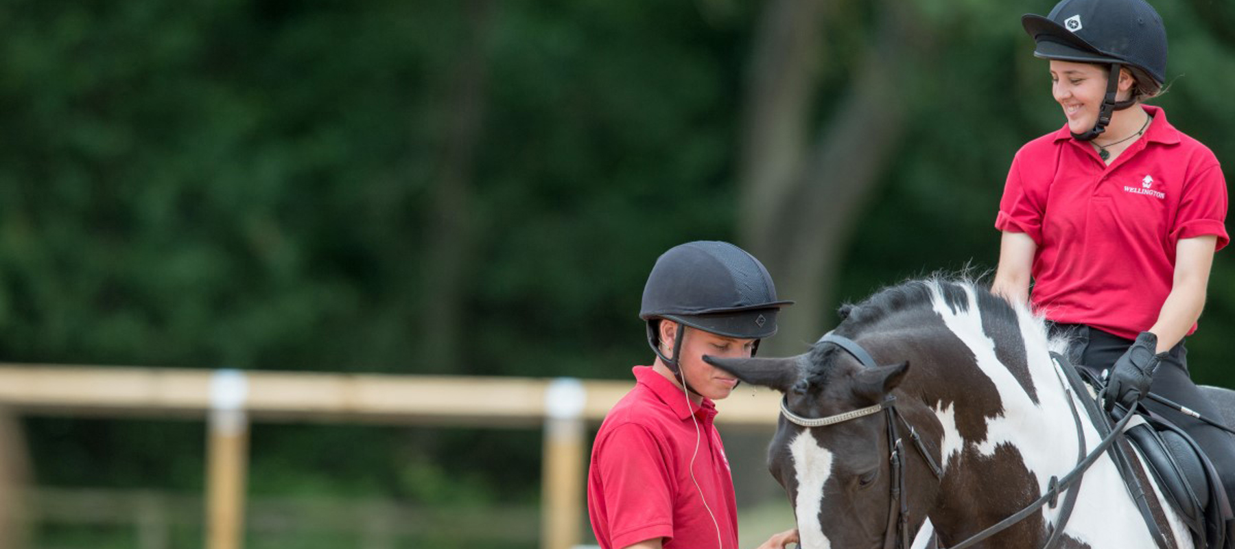 two young riders near a horse